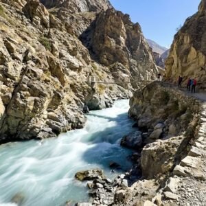 Fast flowing turquoise glacial river cutting through a rocky gorge on the Nangma Valley trekking trail, Hushe Skardu northern Pakistan