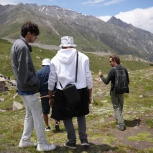North Nomads guide leading a group of trekkers on the mountain trail above Fairy Meadows, northern Pakistan