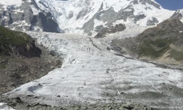 Rakaposhi glacier flowing beneath the 7,788m summit under a deep blue sky, Rakaposhi Base Camp trek northern Pakistan
