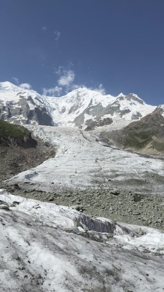 Rakaposhi glacier flowing beneath the 7,788m summit under a deep blue sky, Rakaposhi Base Camp trek northern Pakistan