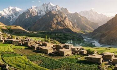 Remote traditional stone village of Shimshal nestled in a narrow Karakoram valley with terraced green fields, Hunza northern Pakistan