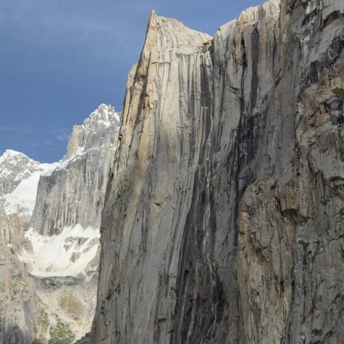 Waterfall on Granite Wall, Nangma Valley, Skardu, Gilgit-Baltistan Description: A thin waterfall streaks down a massive granite face in Nangma Valley, Skardu district, Pakistan, one of the striking rock formations trekkers pass en route through this Karakoram range valley.